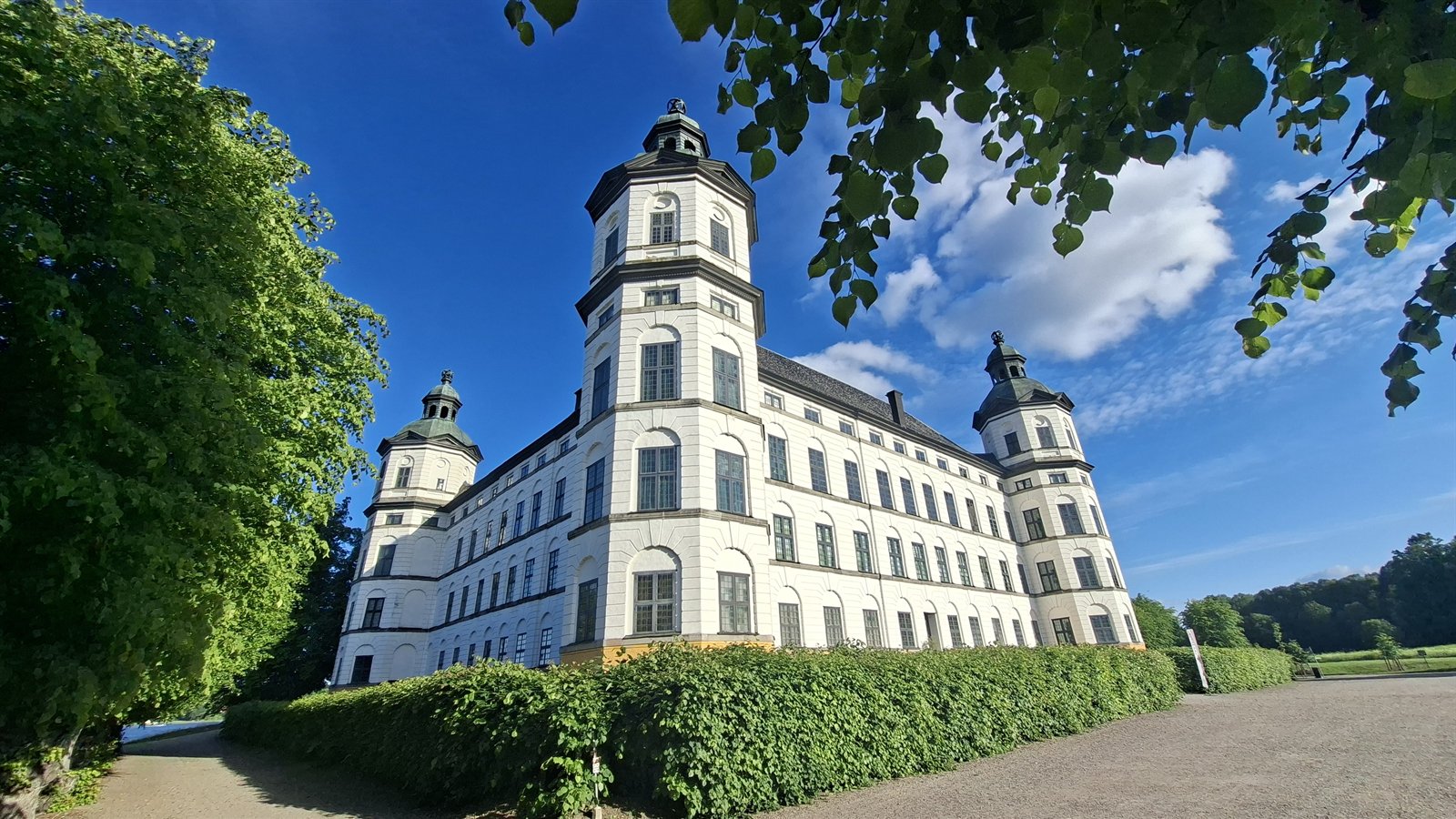 A castle in early summer, the grounds green and full.